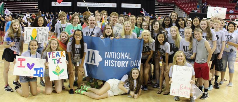 Large group of National History Day student participants with banners