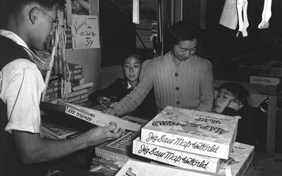 Japanese-American family shops for toys at the Manzanar Relocation Center. 