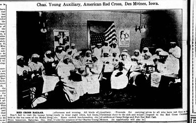 Photo from the Bystander published in December 20th, 1918, of several women that belong to the Chas. Young Auxillary, American Red Cross in Des Moines, Iowa.  The women all appear to be sewing.