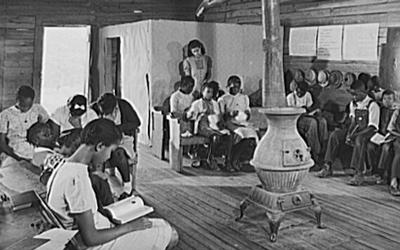 The photograph features a classroom of a school of only black children in Veazy, Georgia in 1941.