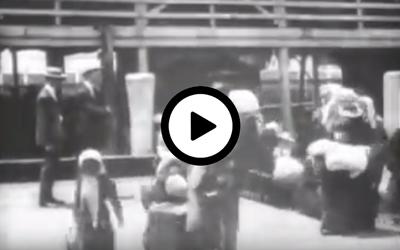 "Emigrants Landing at Ellis Island," a contemporary Edison film, shows a large open barge loaded with people of many nationalities, who just arrived from Europe.