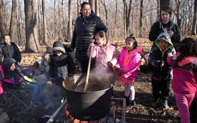 Meskwaki Members Show Settlement Students the Maple Syrup Process, March 2018