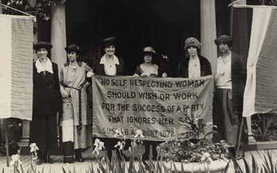 This photograph, taken at the June 1920 Republican National Convention in Chicago, depicts six suffragists (including Alice Paul, second from the right) gathered in front of a building with suffrage banners, one of them quoting the influential suffragette Susan B. Anthony.
