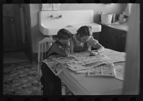 Children Reading the Sunday Newspaper in Dickens, Iowa, December 1936