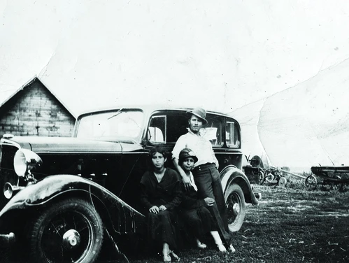 Rivera and Ayala family members lean against a car