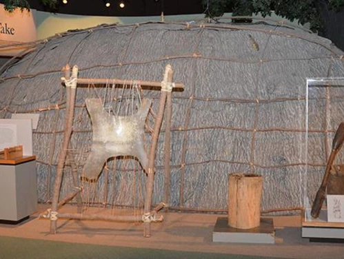 A Native American longhouse model on display at the museum