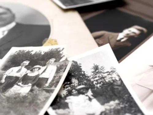 Pile of black and white portrait photographs.