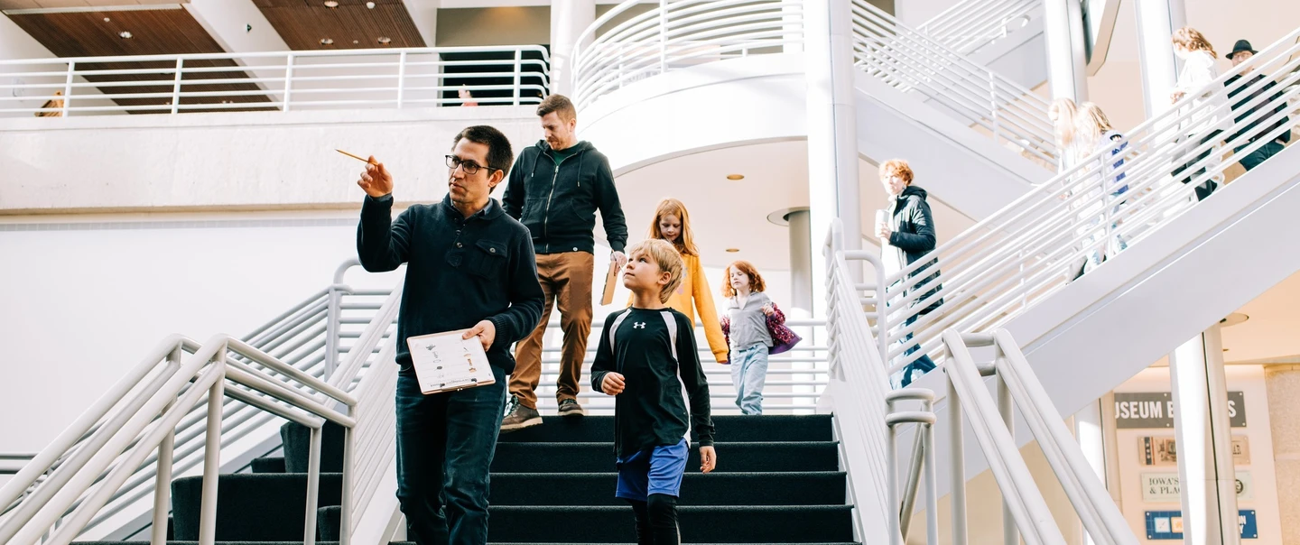 A tour guide shows around a family at the history museum