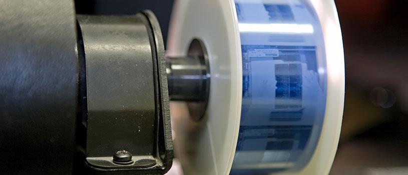Up close view of newspapers on microfilm strip