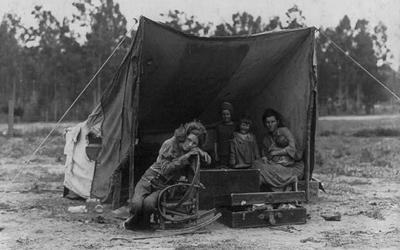 Photo shows Florence Thompson with several of her children in a tent shelter as part of the "Migrant Mother" series.