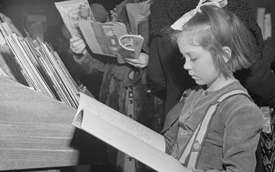 Little Girl Looking at Book in R.H. Macy and Company Department Store in New York, December 1942 