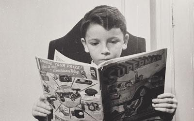 German Refugee Child Reading a Comic Book, October 1942