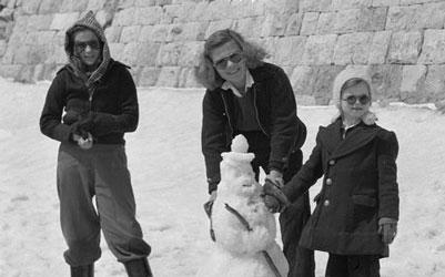 Family Builds Snowman While Waiting for Lunch, March 1946