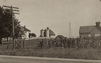 Stereograph showing a view of a farm, house, barn and other buildings on the property.