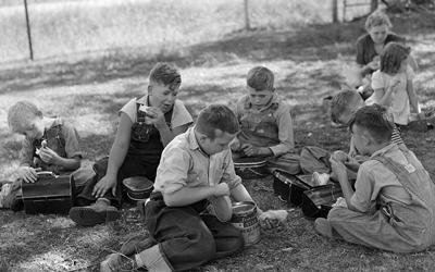 The photo shows lunch hour at a country school in Grundy County, Iowa.