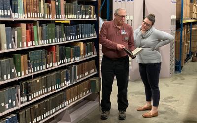 Librarian Bruce Kreuger helping a patron find information in the State Historical Archives. 