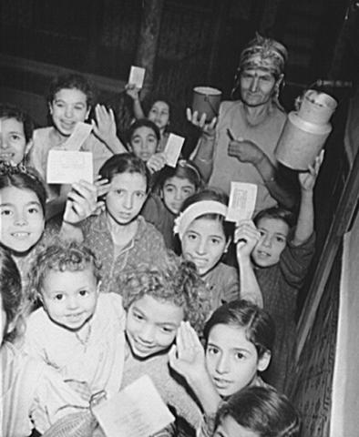 Black and white image of women and children receiving aid in Tunisia.  
