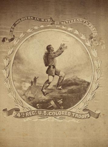 This is a photograph of the United States Colored Troops, 24th Regiment’s flag. On it is an African-American soldier standing atop a hill in the middle of a battlefield with his arms stretched upwards towards the words “Fiat Justitia.” 