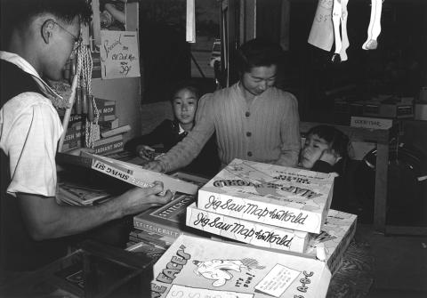 Japanese-American family shops for toys at the Manzanar Relocation Center. 