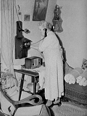An Iowa resident calls a switchboard operator to connect her call in 1940. 