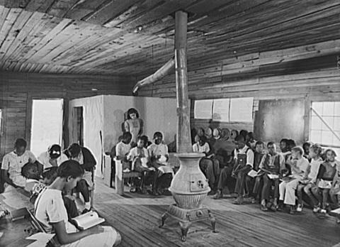 The photograph features a classroom of a school of only black children in Veazy, Georgia in 1941.