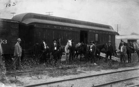 Union Pacific posse car being loaded with men and horses in 1900