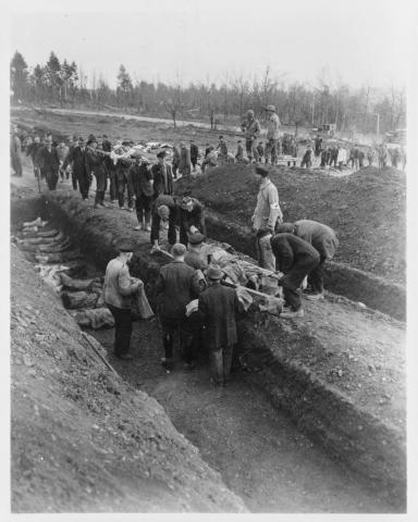 Image shows people in Germany digging mass graves for people killed in a concentration camp.
