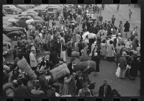 Japanese Americans with their baggage waiting for trains which will take them to Owens Valley.