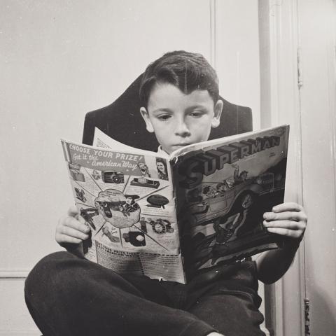 German Refugee Child Reading a Comic Book, October 1942