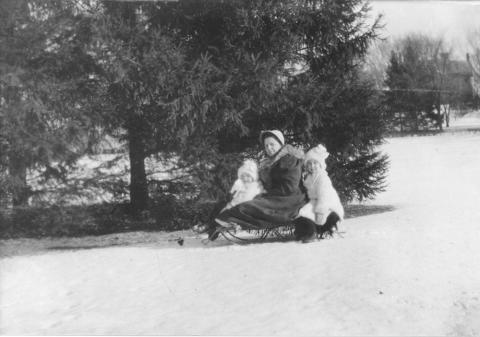 Ellen and Barbara Douglas on a Sled with their Nanny "Danny," Date Unknown