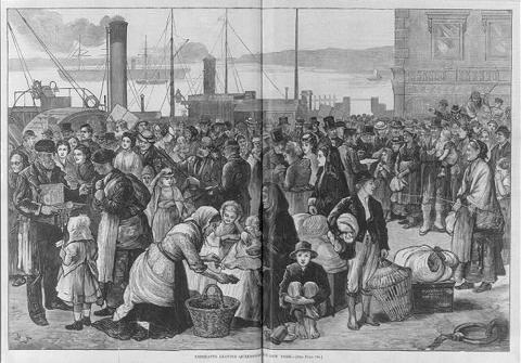 This 1874 engraving shows men, women and children on a dock in Queenstown, Ireland preparing to board a ship that will take them to New York.