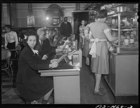 African Americans eating at a local Chicago restaurant owned by African American Mr. E. Norris in 1942.  Most diners and employees are black, and several small businesses in this area of Chicago were owned and operated by African Americans who had migrated north during the Great Migration.