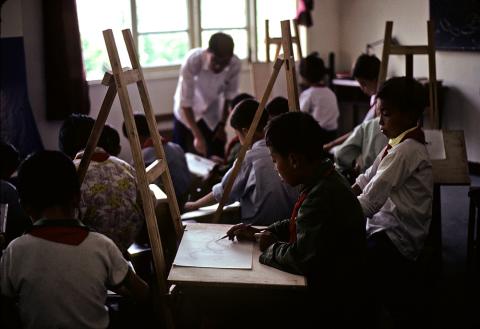 Children learning to draw in an art class at a "commune school" in China.