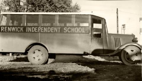 Motorized, wooden bus with “Renwick Independent School” printed on the side.