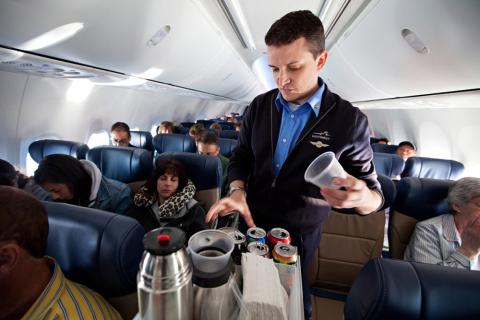 Southwest Airlines Flight Attendant serves beverages on flight