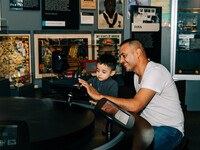 A man and child explore the collection on iPads in the Visible Vault exhibit