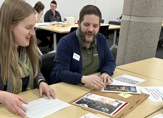 Two adults work on escape room