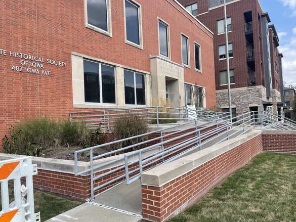 Exterior view of the Centennial Building entrance on Iowa Avenue with ramp