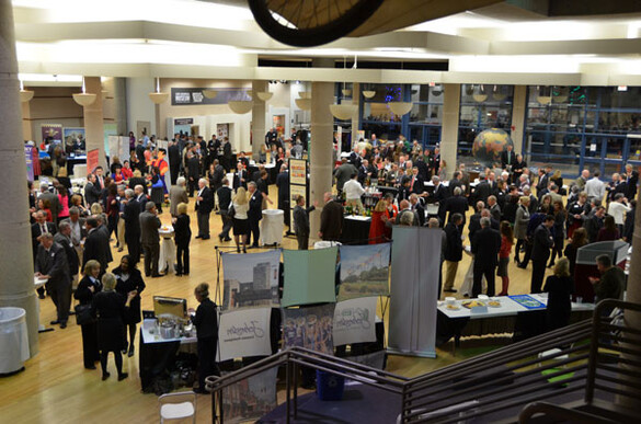 State Historical Building atrium set up for an event expo filled with banners, tables, and people