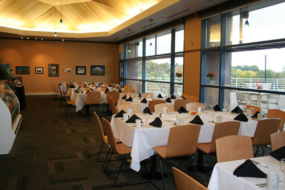 Interior cafe set up for a banquet with tablecloths.
