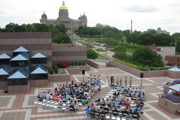 Wedding ceremony on the Grand Terrace at the State Historical Building with a view of the Iowa State Capitol.
