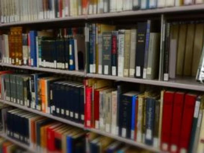 Shelf view of books and periodicals from Historical Library in Des Moines.