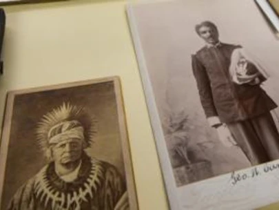 View of photographs from State of Iowa Collections laid out on a table.