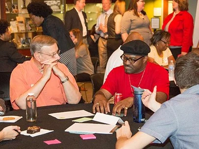 People engaged in a table discussion at a conference